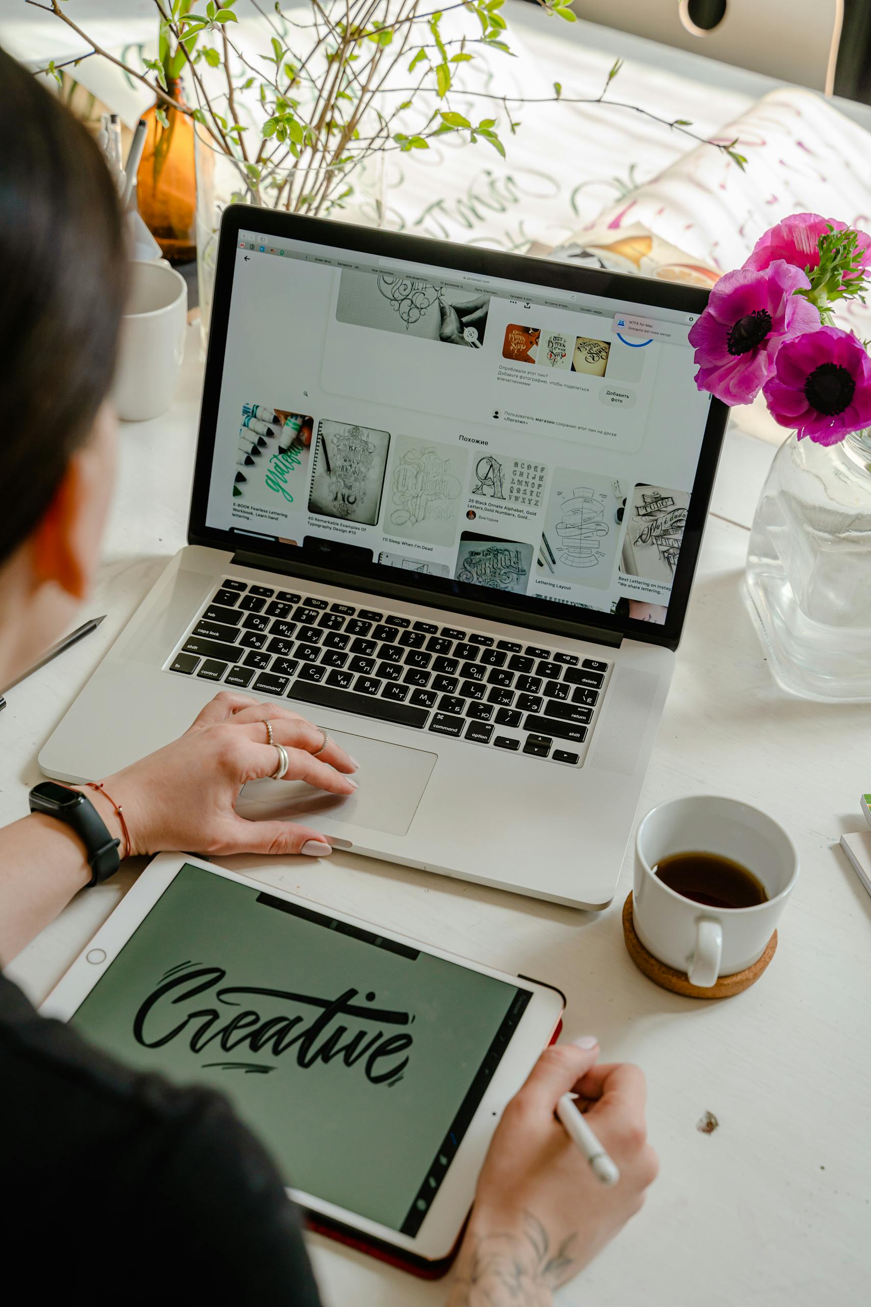 Person Using Macbook Pro on Table wording creative